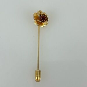 Vintage gold finish flower pin. Bright red stone.